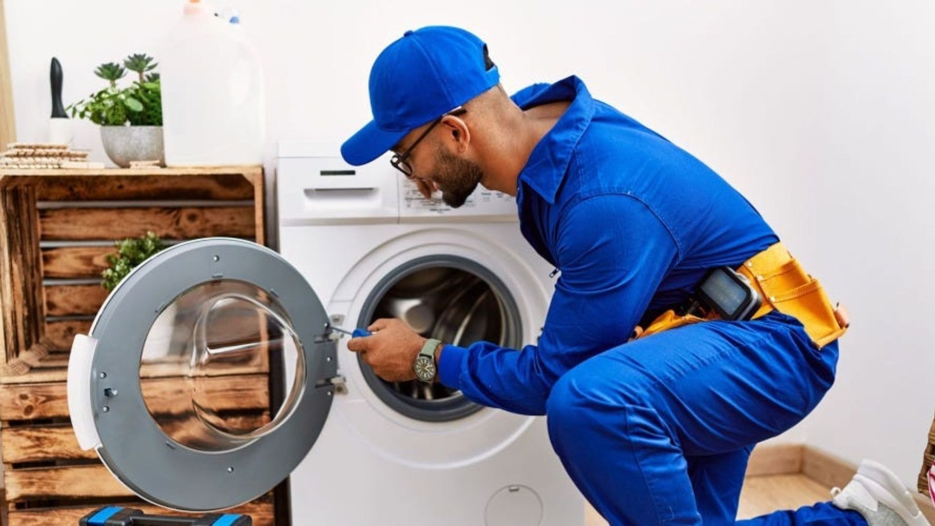 Professional Technician Repairing Washing Machine at Home - Universal Home Enterprises